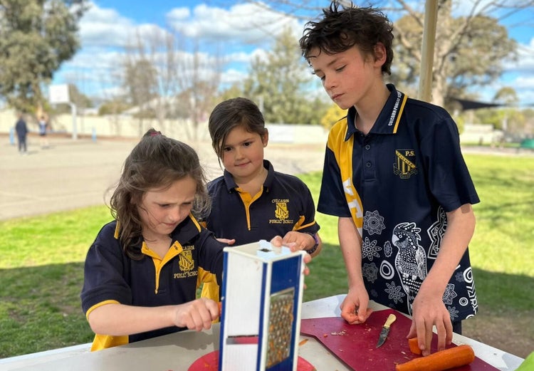 Three students involved in HPGE cooking classes