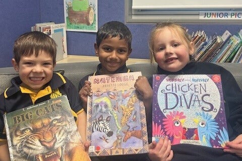 # kinder students showing their picture books